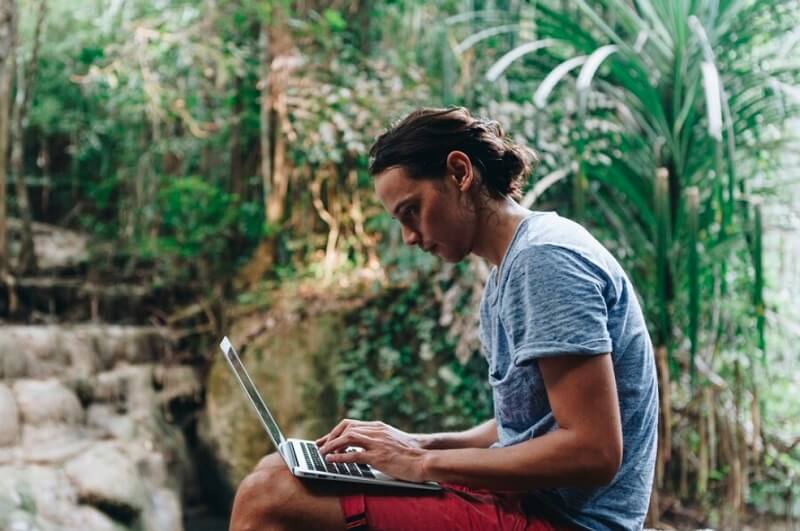 person using laptop in nature